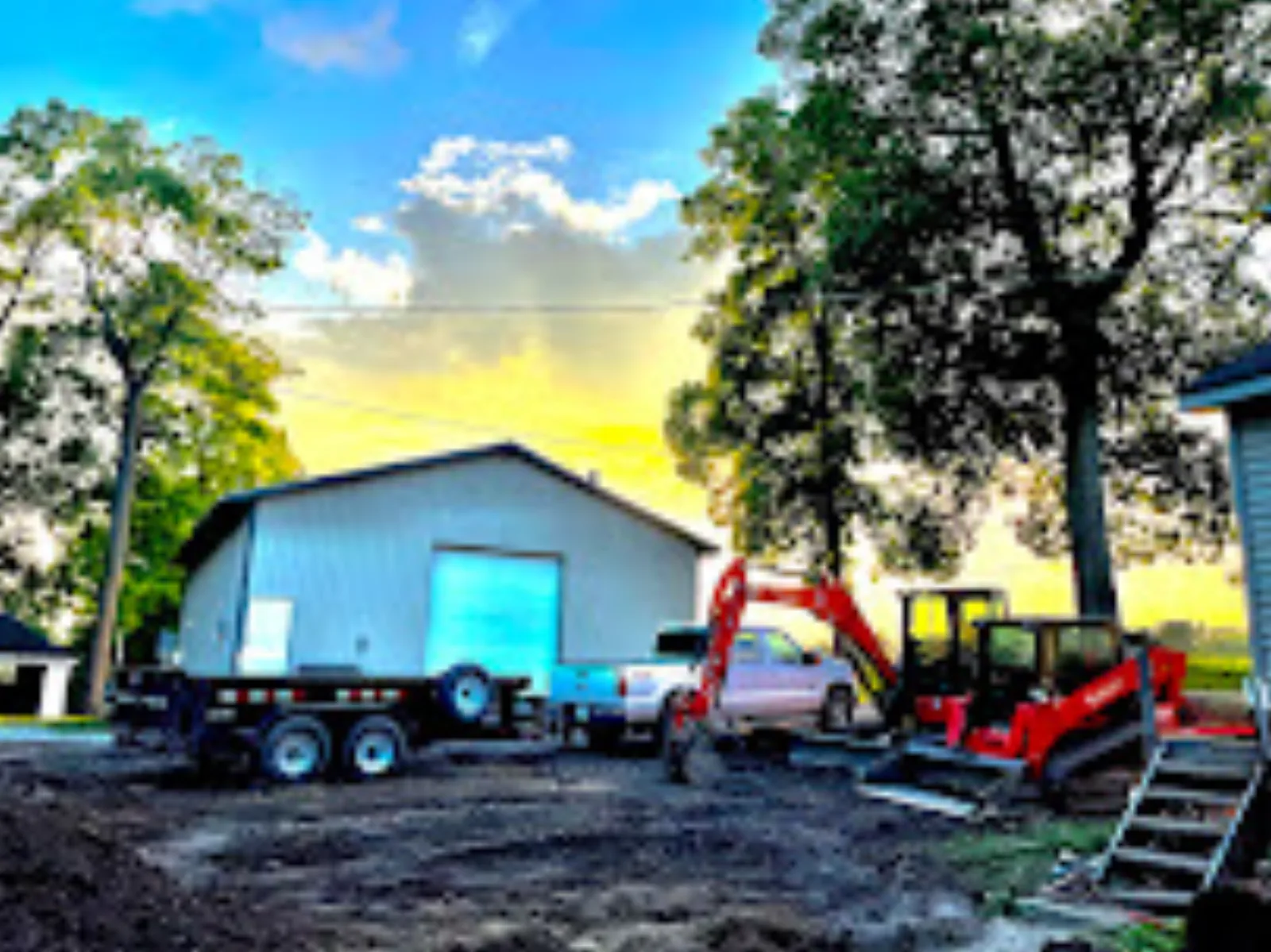 Mini excavators loaded on an equipment trailer at the end of a day, ready to travel to a Westfield, Indiana job